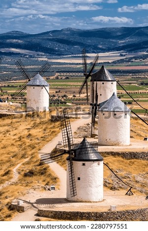Series of windmill of Consuegra on the hill and in the background the plain of La Mancha (Spain) Royalty-Free Stock Photo #2280797551