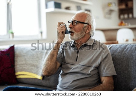 Older man having asthma attack due to his allergies. Mature man using medical inhaler to prevent and treat wheezing and shortness of breath caused by allergy. Royalty-Free Stock Photo #2280810263