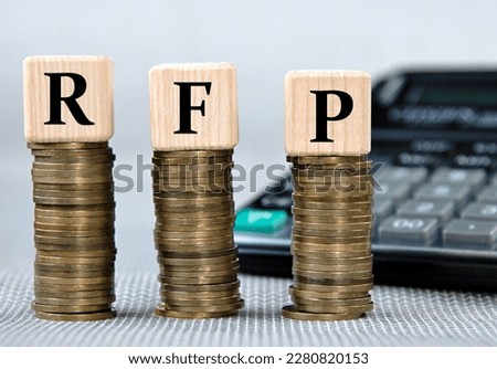 RFP (Request for proposal) - acronym on wooden cubes on the background of coins and calculator. Business and finance concept Royalty-Free Stock Photo #2280820153