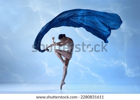Flying fabric. Aesthetic of classical dance. One young ballerina wearing beige bodysuits emotional dancing with fabric silk. Concept of classic ballet, inspiration, beauty, dance, creativity