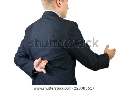 Businessman with his fingers crossed behind his back - concept for good luck or dishonesty 