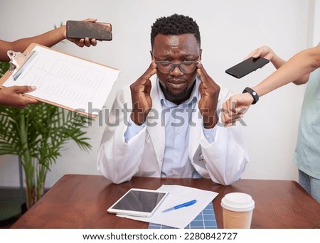 Stressed and overwhelmed doctor concept, priorities and healthcare workload Royalty-Free Stock Photo #2280842727