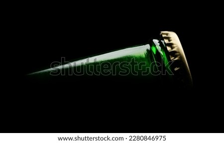 Closeup photo of  green beer bottle on black background