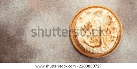 Pita bread on a wooden board. Traditional Arabic cuisine. Long banner format. top view. Royalty-Free Stock Photo #2280850729