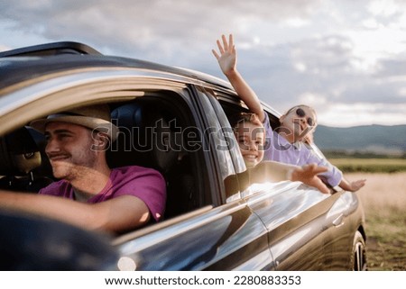 Happy family enjoying drive in their new electric car. Royalty-Free Stock Photo #2280883353