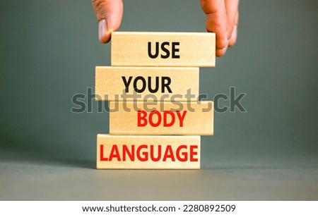 Use your body language symbol. Concept words Use your body language on wooden block. Beautiful grey table grey background. Motivational business Use your body language concept. Copy space.