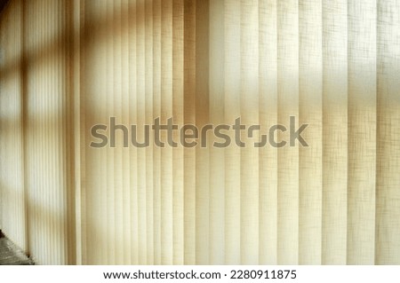 Curtains with adjustable vertical slats made of fireproof fabric to regulate ambient light Royalty-Free Stock Photo #2280911875
