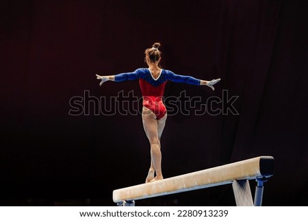 back female gymnast athlete balancing on balance beam gymnastics, sports summer games  Royalty-Free Stock Photo #2280913239