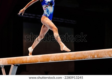 legs female gymnast exercise balance beam gymnastics on dark background, sports summer games 