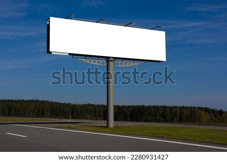 White billboard along the highway. Background for design and advertising.  Royalty-Free Stock Photo #2280931427