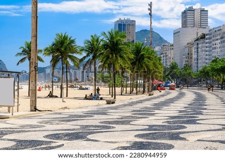 View of Leme beach and Copacabana beach with palms and mosaic of sidewalk in Rio de Janeiro, Brazil. Copacabana beach is the most famous beach in Rio de Janeiro. Sunny cityscape of Rio de Janeiro Royalty-Free Stock Photo #2280944959
