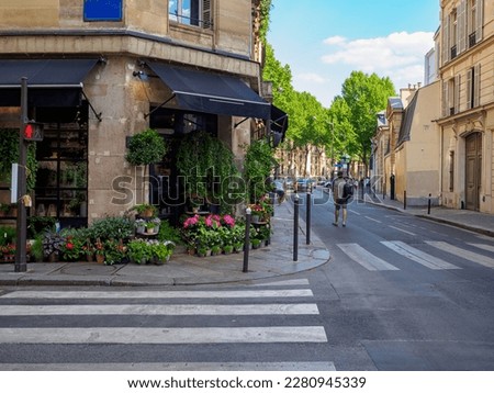 Cozy street with flower shop in Paris, France. Architecture and landmark of Paris. Cozy Paris cityscape Royalty-Free Stock Photo #2280945339