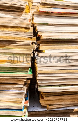 A column of old books with the pages yellowed by time stacked on top of each other. High quality photo