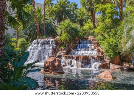 Beautiful view of waterfall and tropical trees on background. Las Vegas. USA.