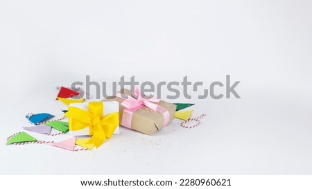 Presents and colorful garland on white background. Stock image suitable as birthday card or banner