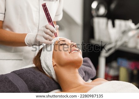 Shot of a beautiful young woman on a facial dermapen micro-needling treatment at the beauty salon. Royalty-Free Stock Photo #2280987135