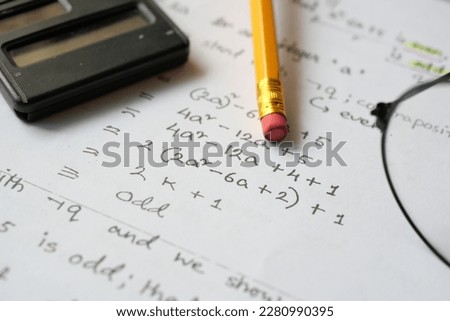 Hand writing algebra equations on a paper  Royalty-Free Stock Photo #2280990395