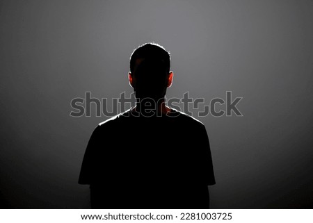 dark backlight shadow silhouette of male person, incognito unknown profile Royalty-Free Stock Photo #2281003725