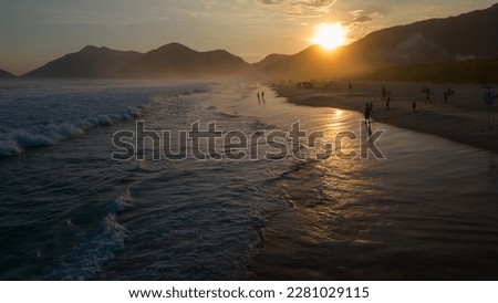 Grumari Beach, Rio de Janeiro, Brazil. Sunset on the beach with lots of waves. Great place for surfing and bodyboarding. Drone photo top View.