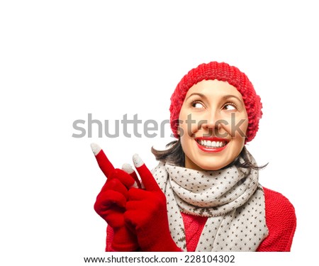 Girl in winter clothes smiling and showing up