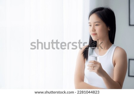 Beautiful young asian woman drinking glass of water mineral pure with fresh and happy at home, asia female drinking beverage for healthcare and weightloss, one person, lifestyles concept. Royalty-Free Stock Photo #2281044823