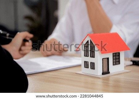 Hands of woman signing agreement and contract for buying house with realtor agent at office, investment real estate and residential, broker approval credit home with client, business concept.