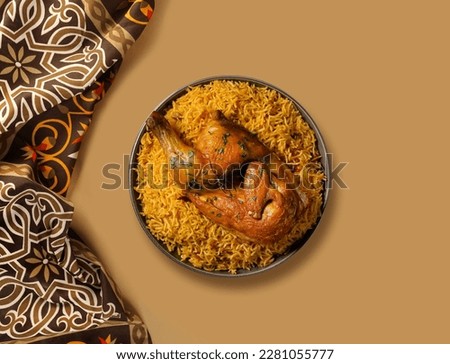 Chicken kabsa - homemade arabian rice, Saudi food. 
The national Saudi Arabian dish chicken kabsa with roasted chicken quarter and almonds Royalty-Free Stock Photo #2281055777