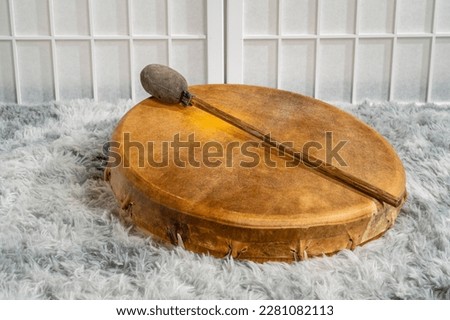 handmade, native American style, shaman frame drum covered by goat skin with a beater Royalty-Free Stock Photo #2281082113