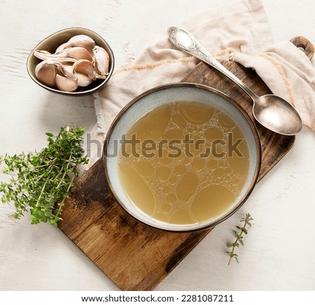 Broth in Bowl on gray background, healthy food, top view Royalty-Free Stock Photo #2281087211