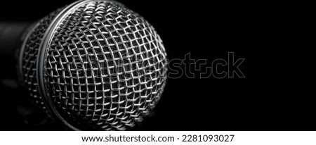 chrome grid wireless microphone on black background closeup, copy space, advertising banner concept