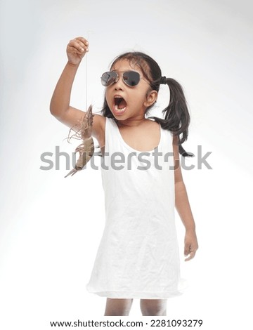 Model girl in white background holding a clay pot with tiger prawns , kerala style wearing sunglasses.