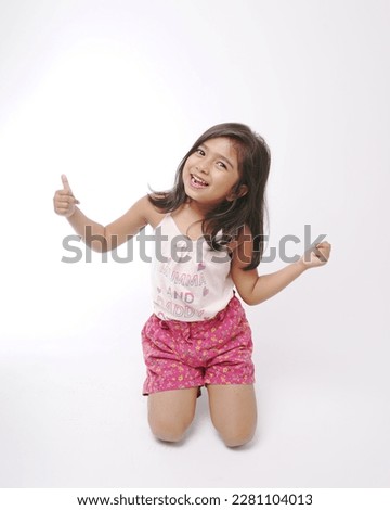 girl model in pink t shirt and pink shorts posing in white background ready to cutout