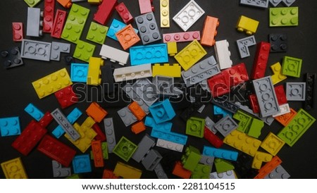 Plastic toy blocks on black background