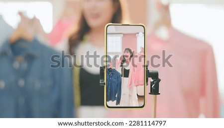 beautiful beautiful asian girl selling fashionable clothes on live streamg at happy and smile atmosphere