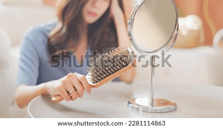 asian girl worry about hair loss - with the comb  Royalty-Free Stock Photo #2281114863