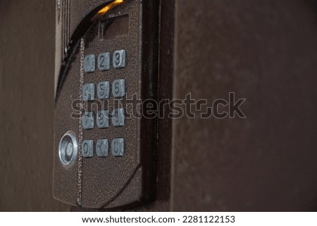 A brown magnetic lock keeps the door closed