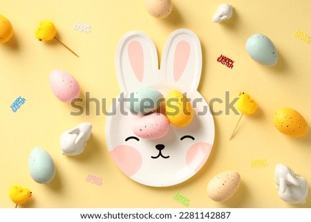 Happy Easter creative layout with tableware and colorful Easter eggs.