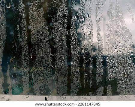 Vapor mirror car. View of a car side mirror from inside the car and rain on the glass window. blurred background texture