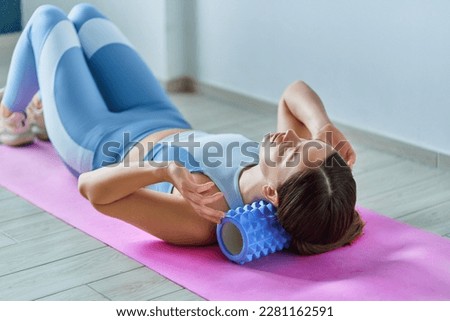 Roller for self neck massage and stretching up muscle  Royalty-Free Stock Photo #2281162591