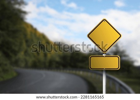 Blank yellow road sign on empty asphalt highway, space for text Royalty-Free Stock Photo #2281165165