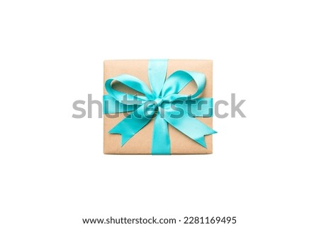 Holiday present box on a Isolated. Gift box with colored bow on white background top view close up.