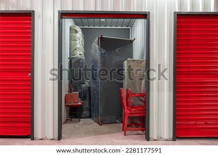 Corridor of self storage unit with red doors. Rental Storage Units Royalty-Free Stock Photo #2281177591