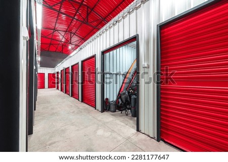 Corridor of self storage unit with red doors. Rental Storage Units Royalty-Free Stock Photo #2281177647