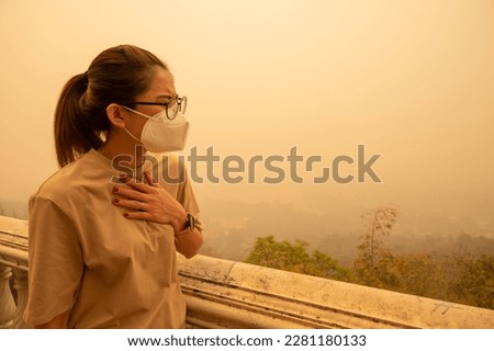 Asian woman having respiratory allergy caused of by Bad air pollution (PM2.5). PM2.5 levels meaning the air quality posed a health hazard. Royalty-Free Stock Photo #2281180133