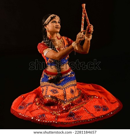 Beautiful portrait of attractive folk dancer giving pose of folk dance called Garba performed in western India to celebrate festival of navratri  #uniqueSSelf Royalty-Free Stock Photo #2281184657