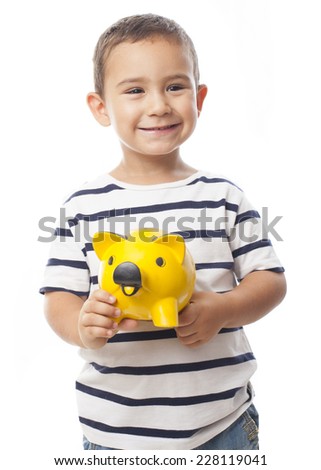 portrait of a little boy holding a piggy bank