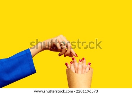 Fast food. Female fingers instead of fries into packaging against yellow studio background. Surrealism and creativity. Food pop art photography. Complementary colors. Copy space for ad, text