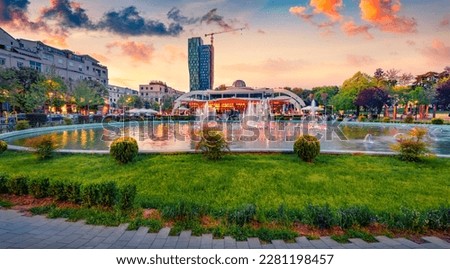 Wonderful spring view of Scanderbeg Square with illuminated fountain. Beautiful sunset in capital of Albania - Tirana. Traveling concept background. Royalty-Free Stock Photo #2281198457