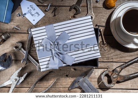 Father day greeting card background. Fathers day concept with gift box, tools and ties, coffee cup, gift tag  Love you dad, on rustic wooden background top view copy space