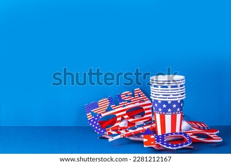 Happy Labor Day, Presidents Day, Fourth of July Independent holiday, Memorial day, Columbus day background. Blue background with USA flag color paper fans and decorations, party accessories